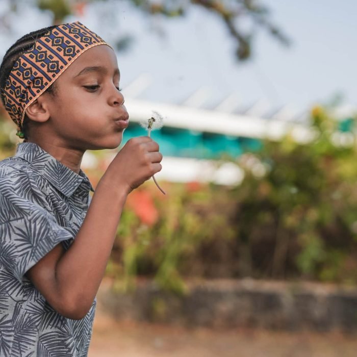 cute-african-boy-blowing-dandelion-outdoor-at-city-park-e1657720778729.jpg